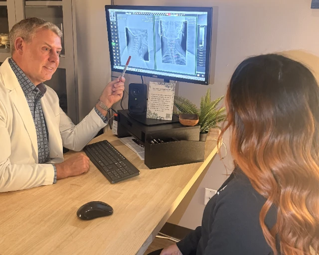 Dr. Bradley Eyford reviewing a spinal X-ray with a patient at Ballard Seattle Chiropractic Center
