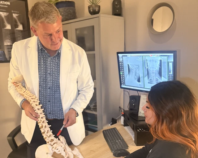 Dr. Bradley Eyford explaining with a spine model at Ballard Seattle Chiropractic Center
