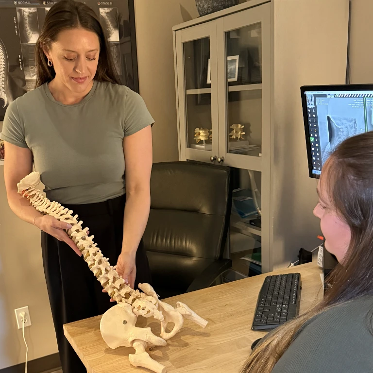 Dr. Lindsey Terronez explaining spinal alignment with a model
